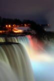 Niagara Falls at night with red lights shinning on the falls